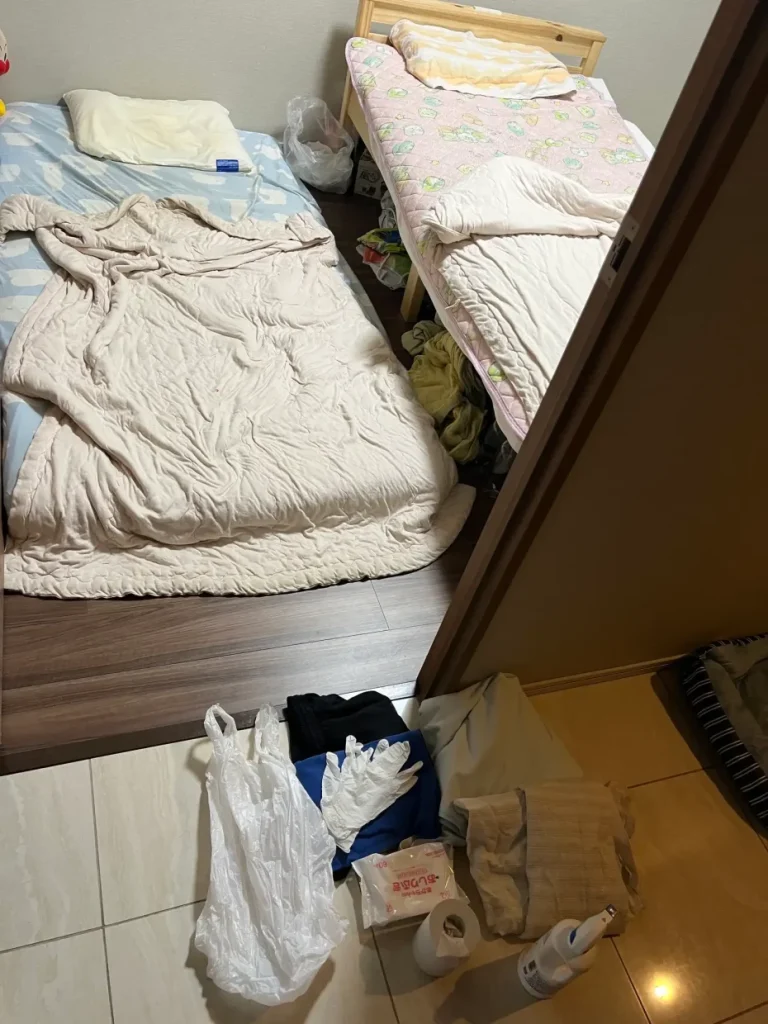 保護者が取れる位置に置いた嘔吐用袋と寝室入口へまとめた片付けセットの再現写真